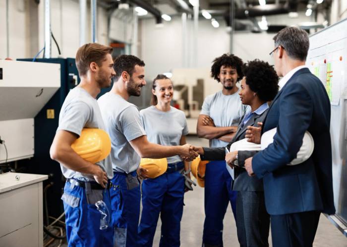 company-managers-visiting-their-employees-factory-happy-african-american-businesswoman-is-shaking-hands-with-one-worker